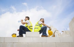 Construction workers take a break from the summer heat and drink water 