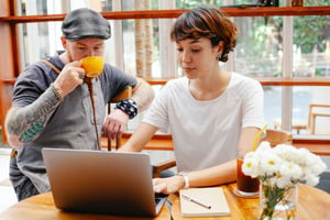 small business employees at a coffee shop update their social media channels