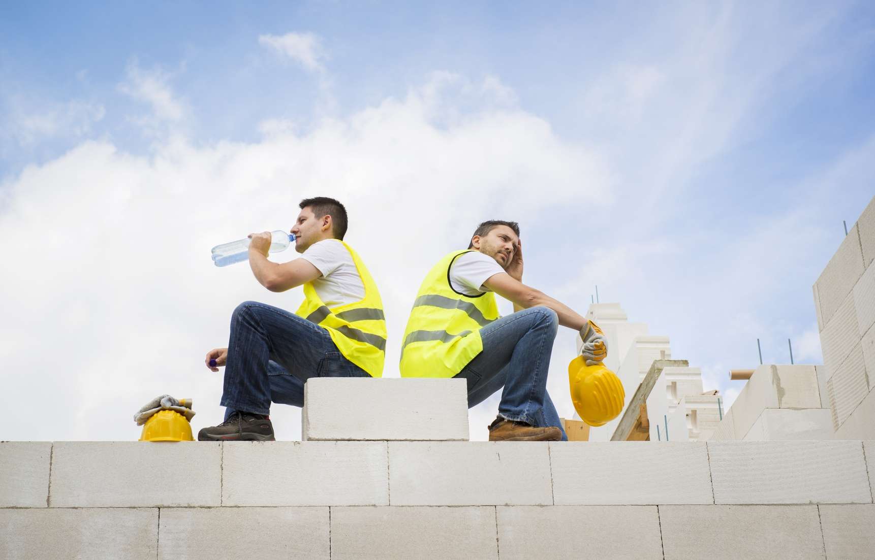Construction workers take a break from the summer heat and drink water 