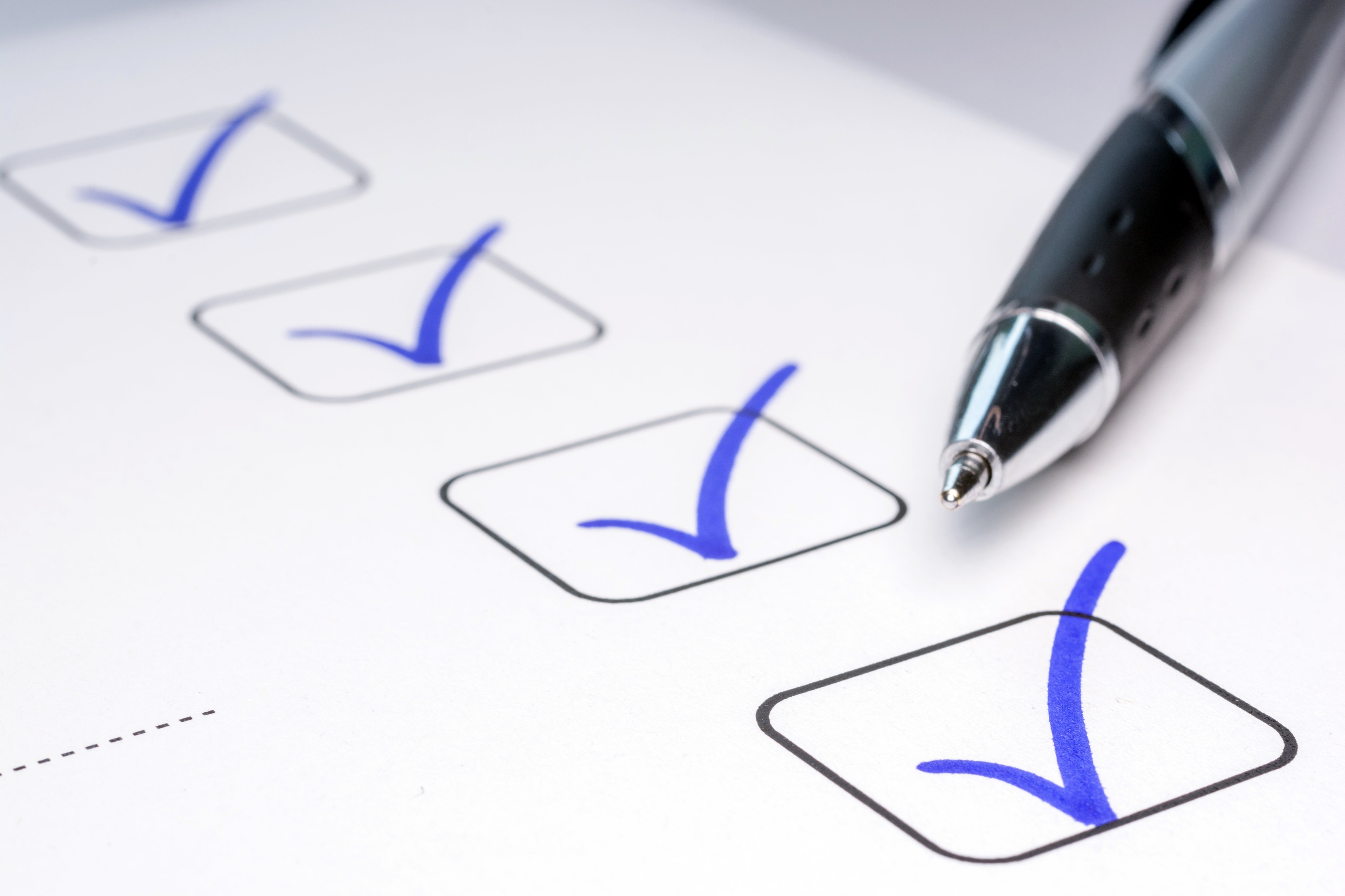 Four blue verification check marks 