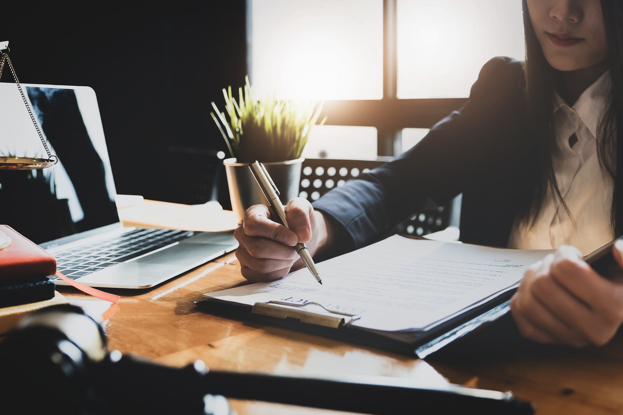 hiring manager writes notes about candidate on clipboard 