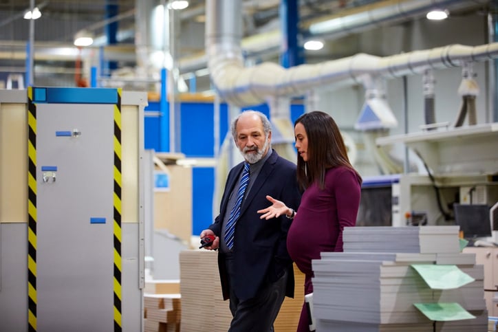 Pregnant employee talking to manager