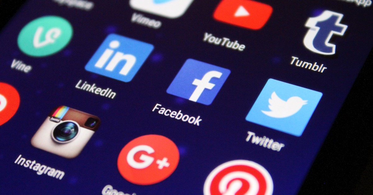 phone screen illuminated with social media app icons